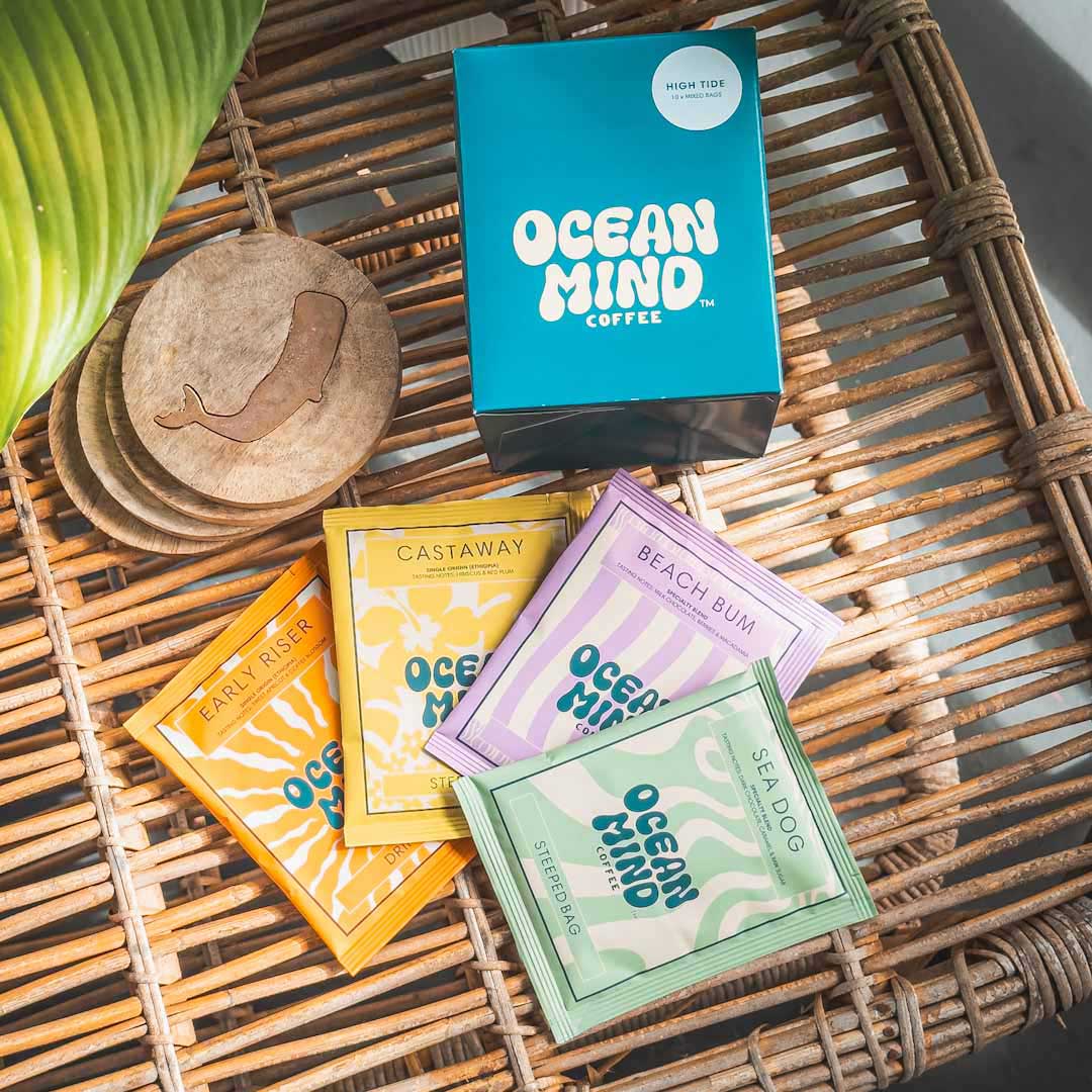 Collection of Ocean Mind coffee packages on a woven surface