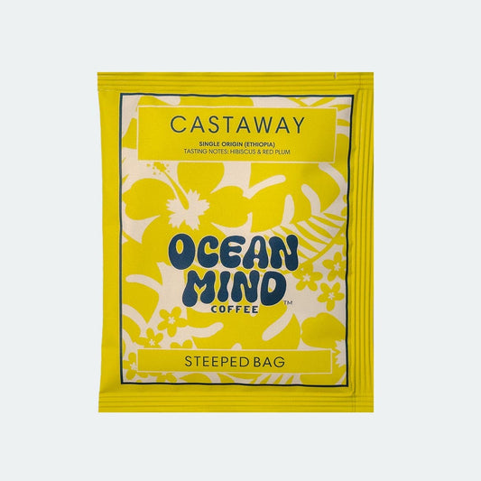 Ocean Mind Coffee 'Castaway' steeped bag with yellow design on a sea mist background