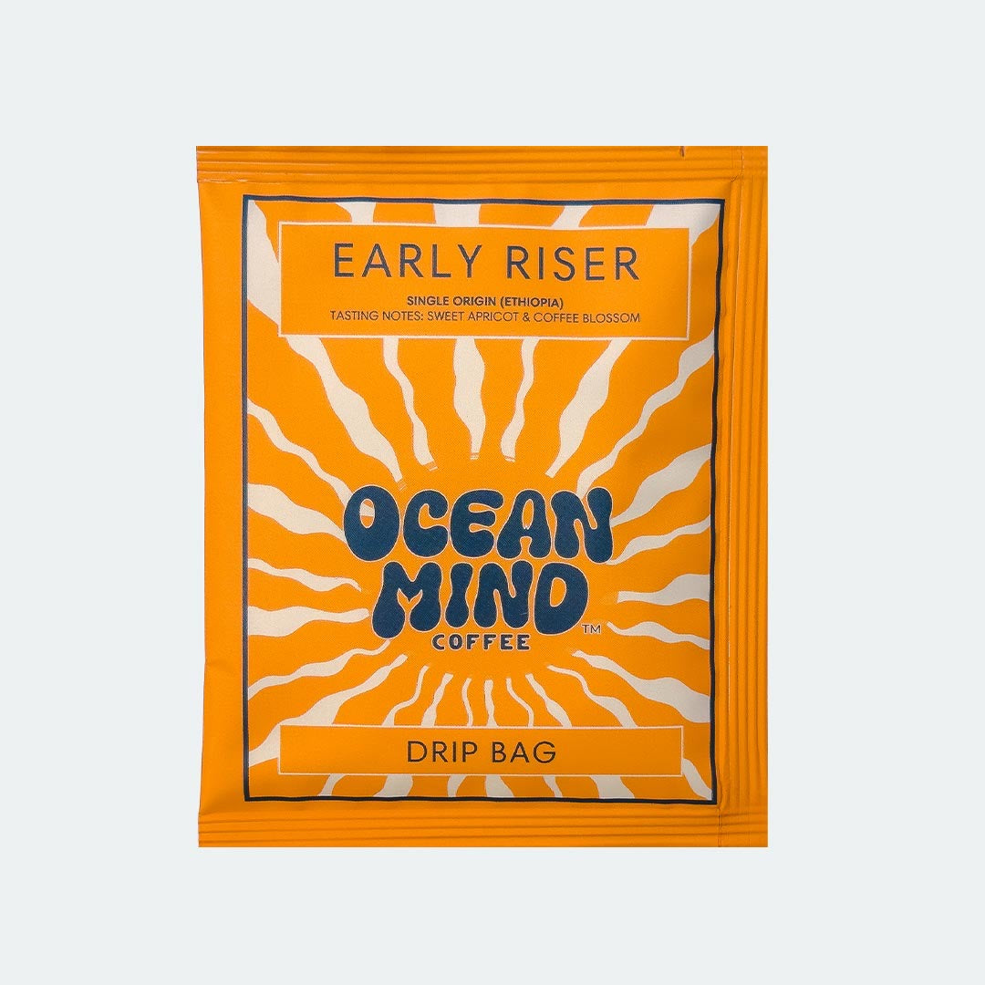 Ocean Mind Coffee 'Early Riser' drip bag with orange design on a sea mist background