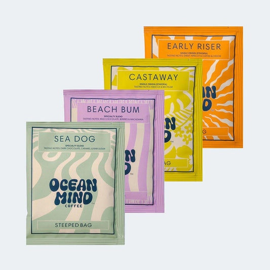 Collection of colourful coffee bags on a sea mist background