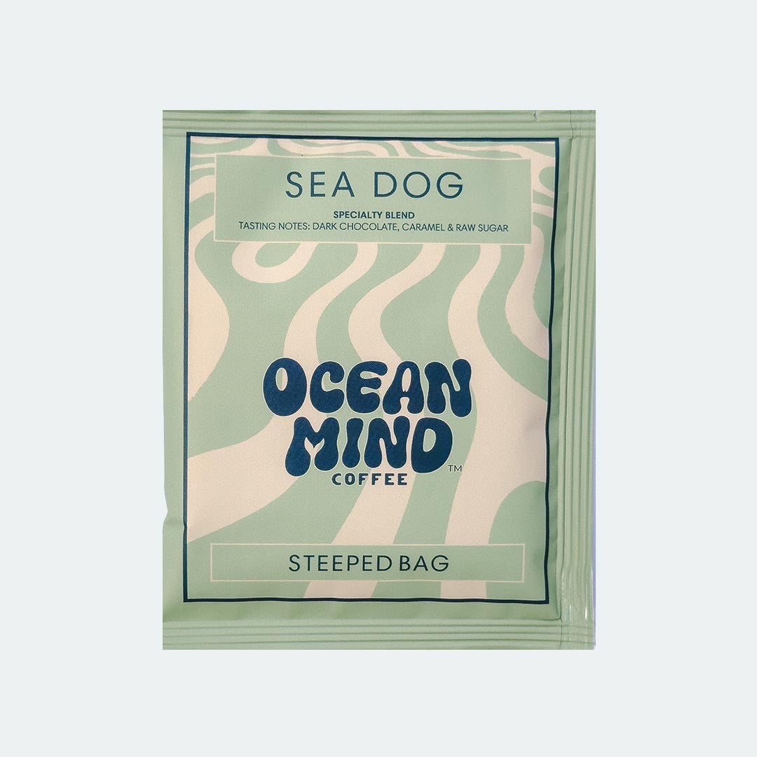 Ocean Mind Coffee 'Sea Dog' steeped bag with green design on a sea mist background