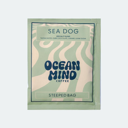 Ocean Mind Coffee 'Sea Dog' steeped bag with green design on a sea mist background